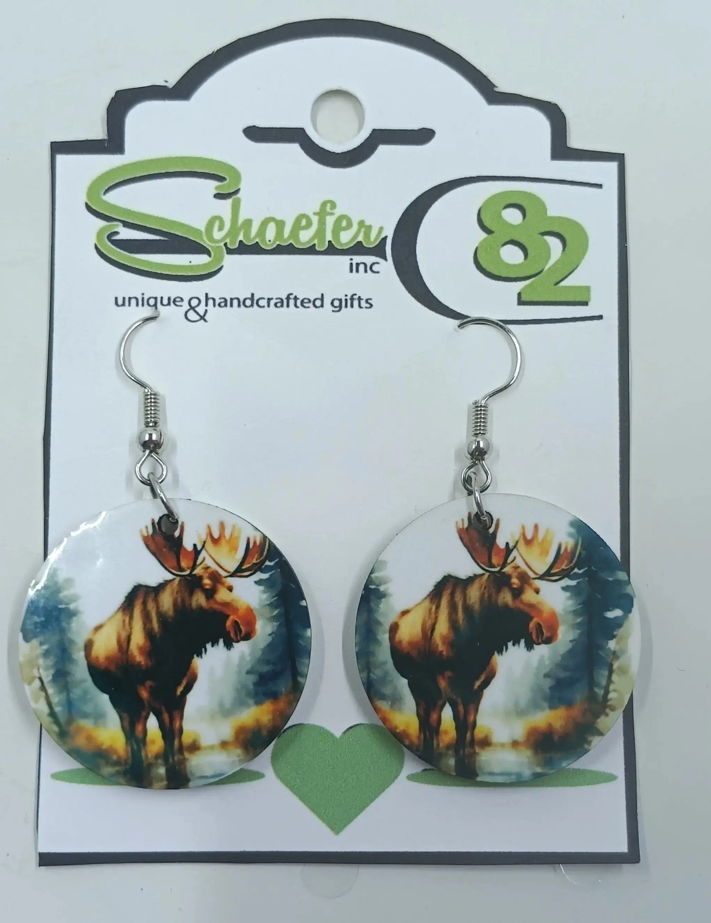 Round Moose Earrings with the forest around him.