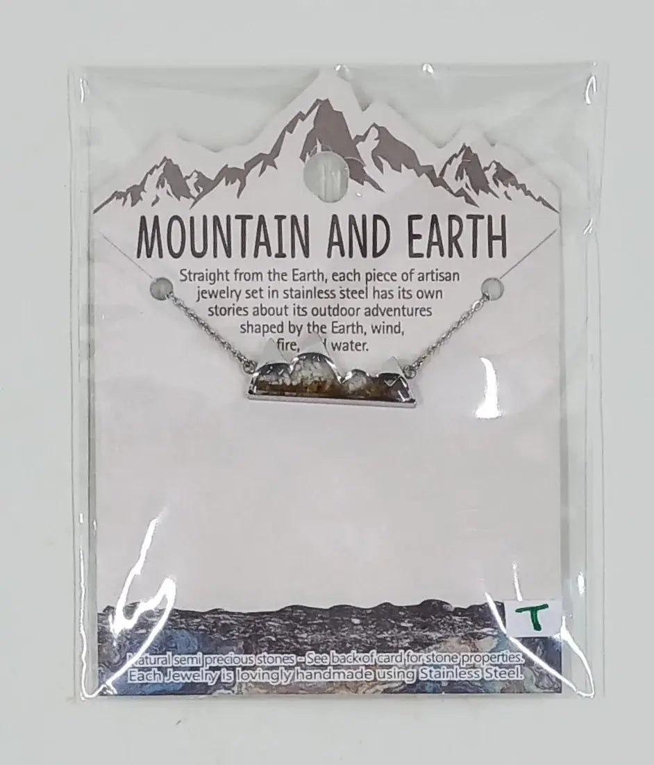 This stainless steel necklace is in the shape of mountains and is filled with white howlite semi precious stones and mineral sand