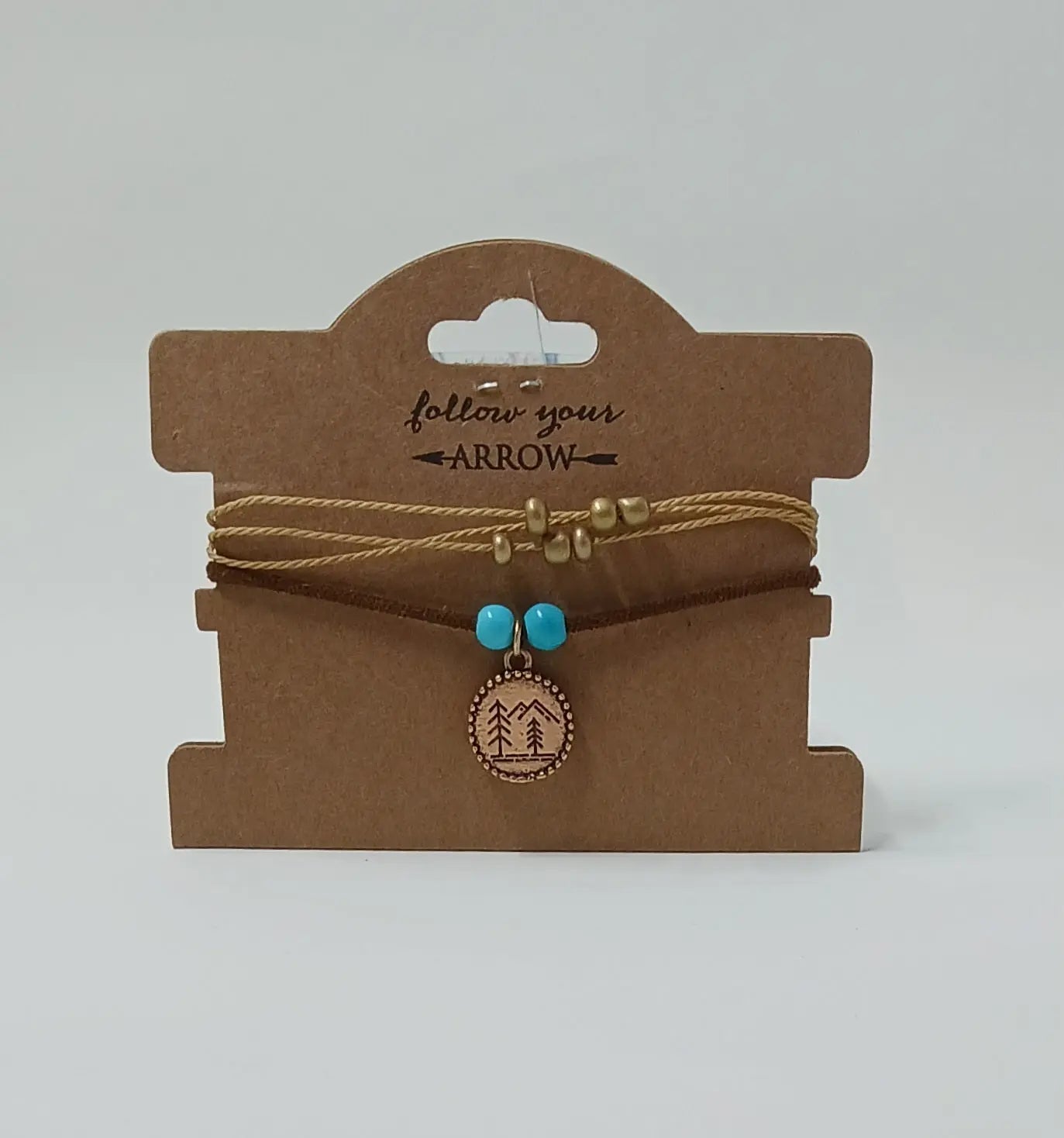 Mountain bracelet with blue and gold beads and a mountain scenery pendant. All made on a braided cord.