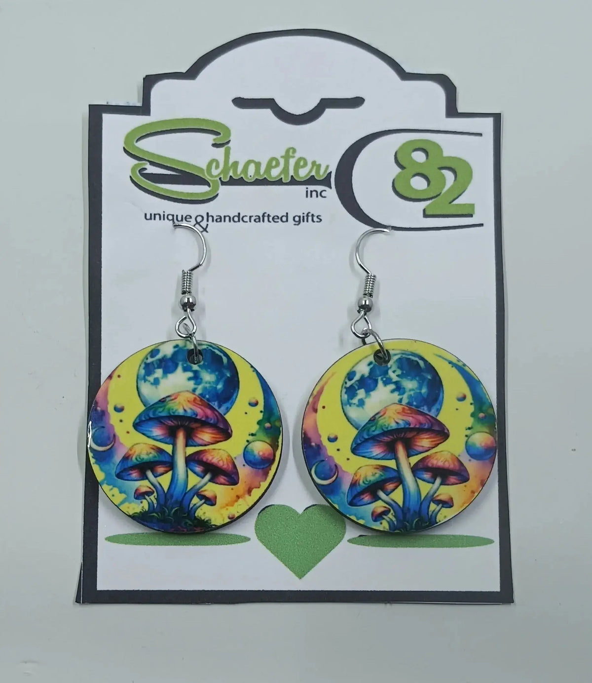 These stunning circular earrings are handmade in Frisco, Co. They are brightly colored yellow with a huge moon and rainbow mushrooms in the forefront.