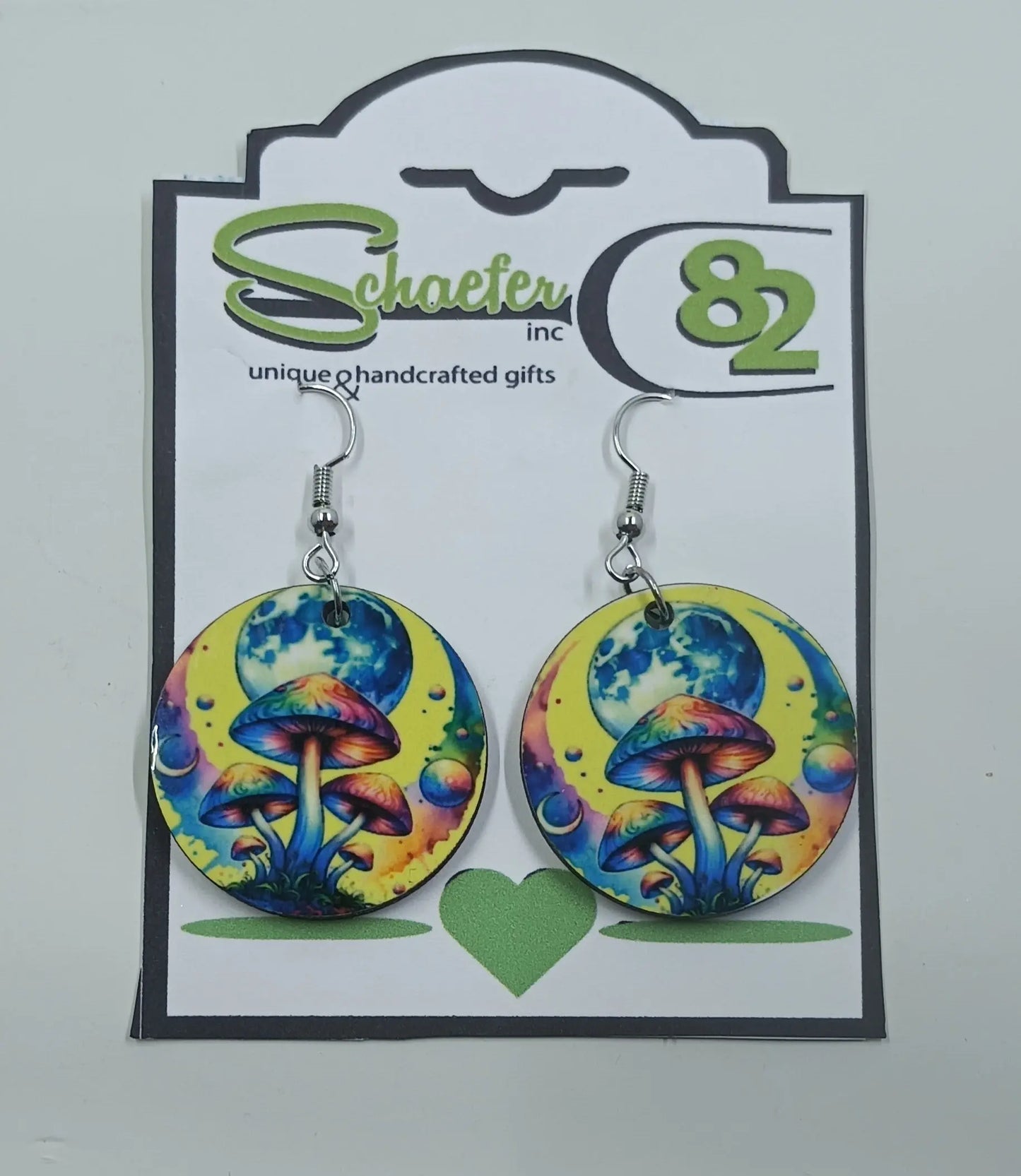 These stunning circular earrings are handmade in Frisco, Co. They are brightly colored yellow with a huge moon and rainbow mushrooms in the forefront.