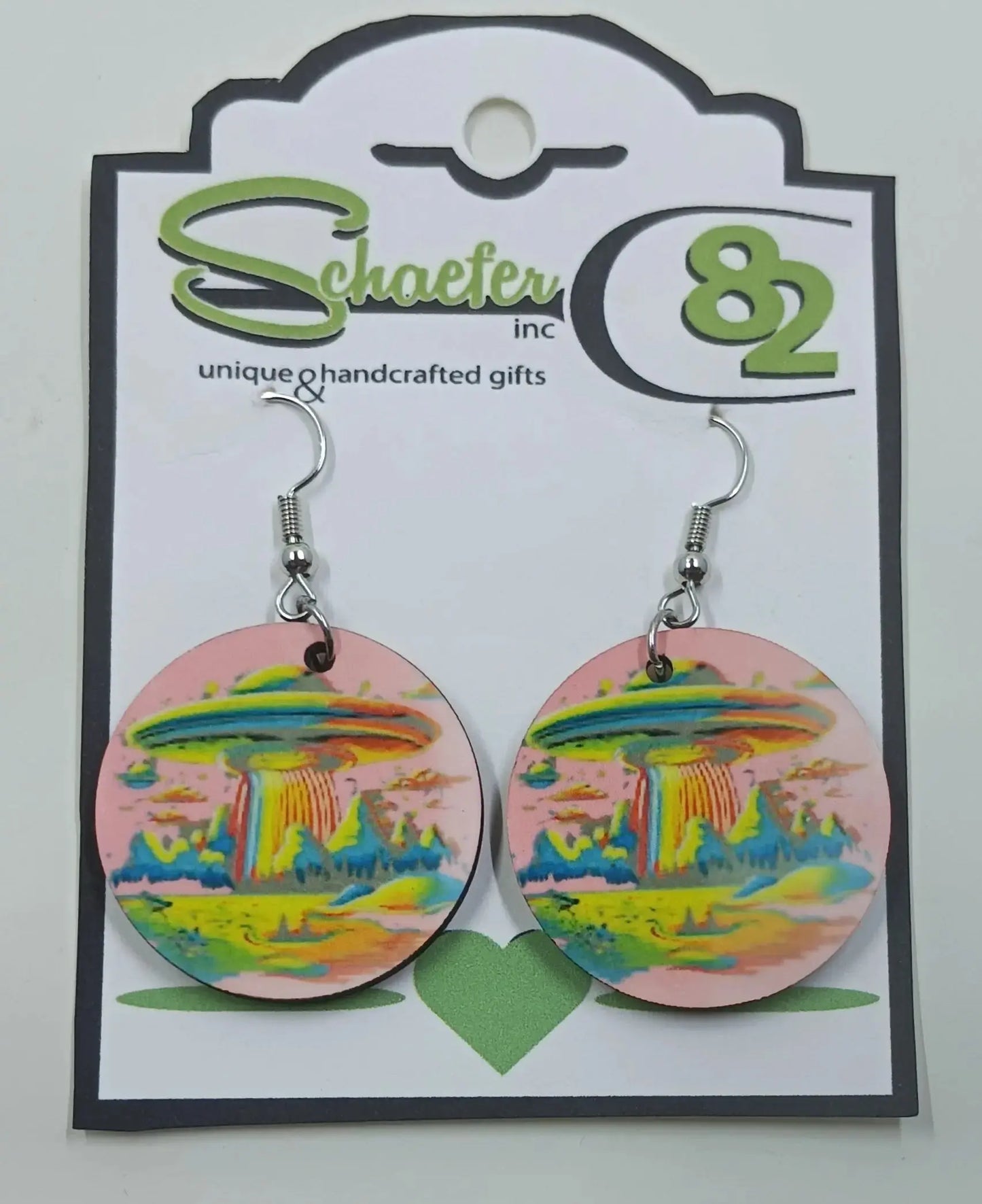 These stunning pink earrings have the image of an alien spaceship on it, with rainbow mountains and scenery.
