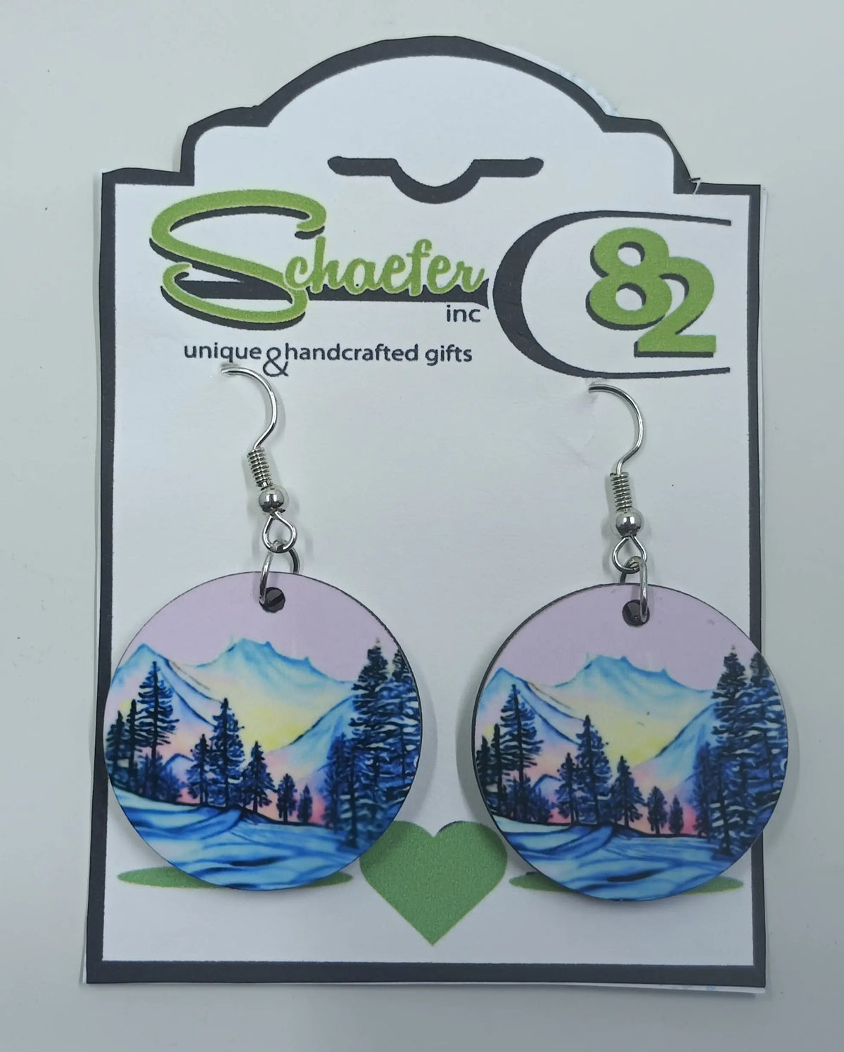 Handcrafted purple mountain earrings that have a purple school and blue mountains in the forefront. 