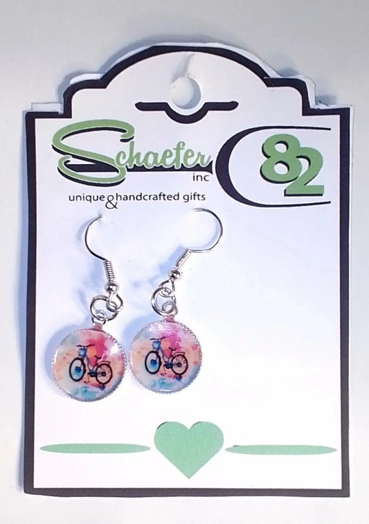 Bike Earrings with a colorful background and covered in Resin:round the mountain gift shop