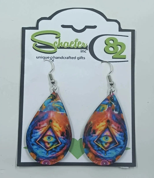 Stunning tear drop earrings that we call third-eye earrings. They are brightly colored with blues and oranges with a triangle in the middle that has an eye in it.