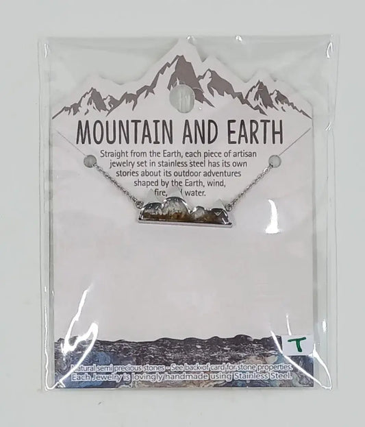 This stainless steel necklace is in the shape of mountains and is filled with white howlite semi precious stones and mineral sand