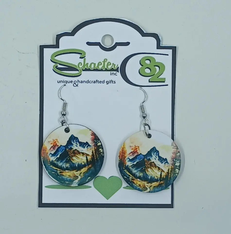 These handcrafted earrings have the image of a mountain scene with a river going down the center of the valley. 