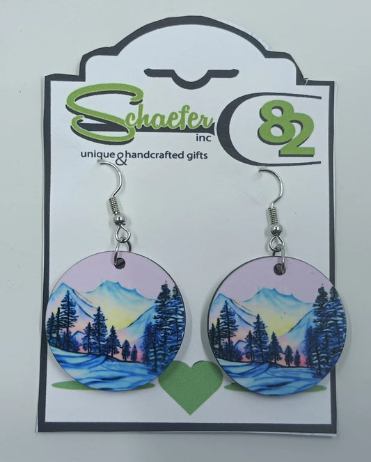 These beautiful earrings are handcrafted and have purple skies with purple mountains and trees in the forefront. 