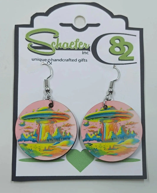 These stunning pink earrings have the image of an alien spaceship on it, with rainbow mountains and scenery.